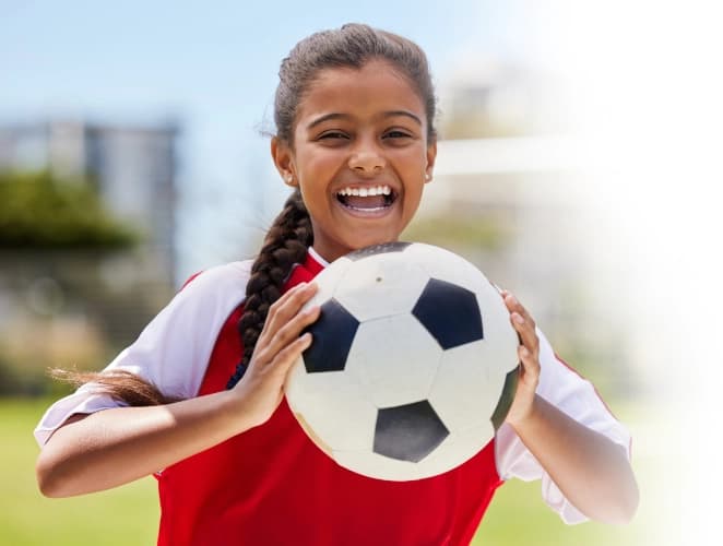 Happy girl with soccer ball